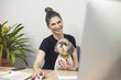 Young business woman with tattoo in pet friendly office